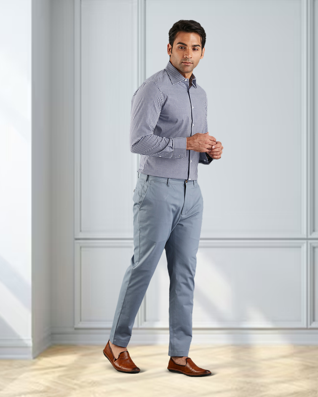 Model wearing custom Genoa Chino pants for men by Luxire in soft blue grey hands together