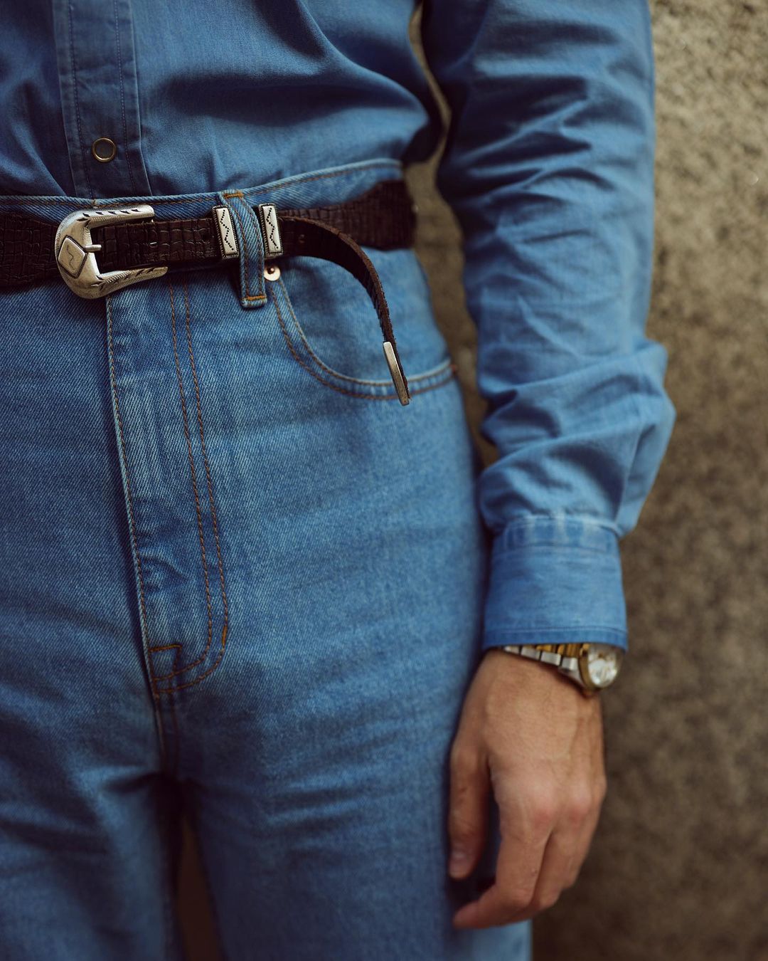 Close up of model wearing mens fade washed jeans by Luxire in indigo