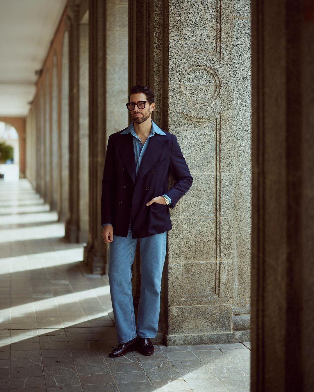 Model outside wearing mens fade washed jeans by Luxire in indigo