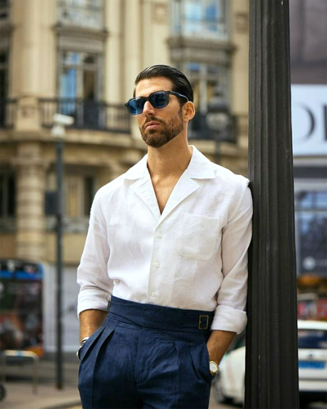 Male model wearing custom linen Gurkha pants for men by Luxire in dark indigo with hands in pockets