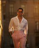 Male model wearing custom linen Gurkha pants for men by Luxire in pink twill